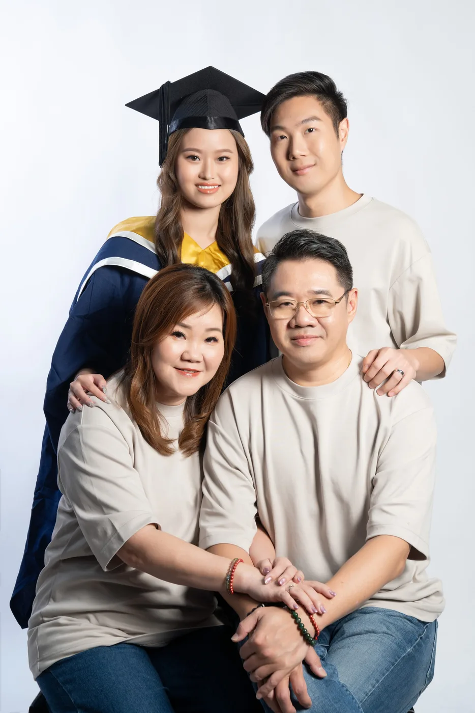 Graduation family photoshoot Singapore - graduate in regalia with family