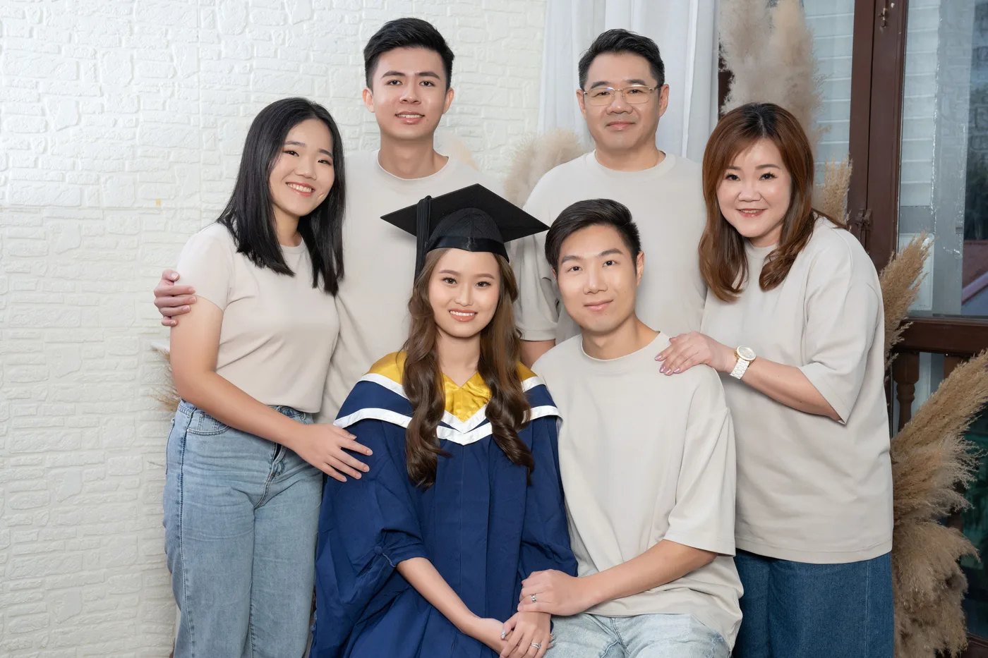 Graduation family photoshoot Singapore - graduate in regalia with family