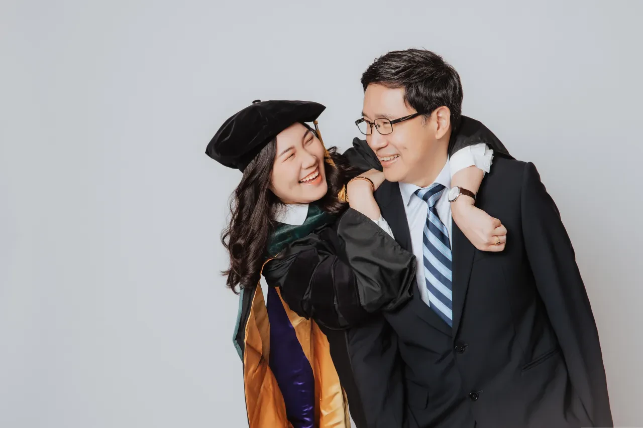 Graduation family photoshoot Singapore - graduate in regalia with family