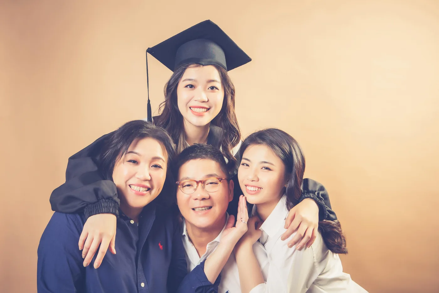Graduation family photoshoot Singapore - graduate in regalia with family