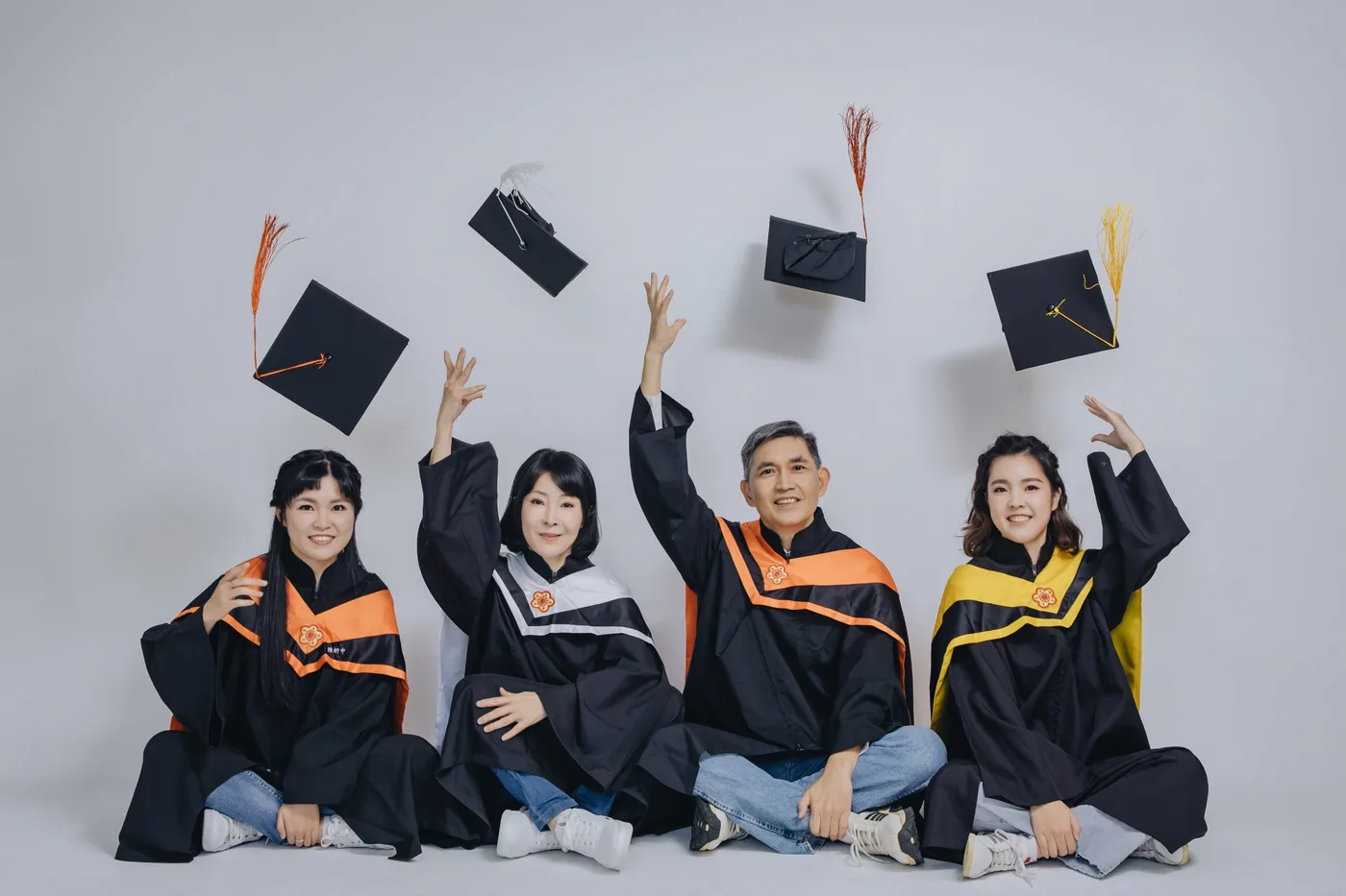Graduation family photoshoot Singapore - graduate in regalia with family