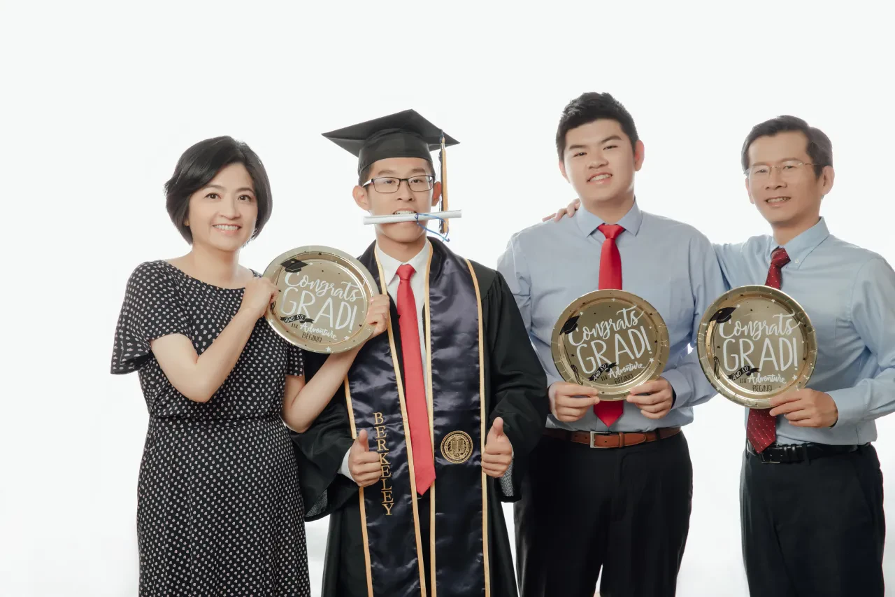 Graduation family photoshoot Singapore - graduate in regalia with family