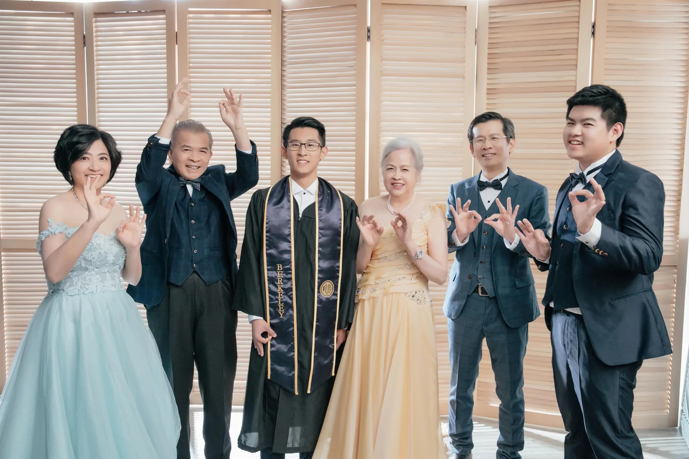 Graduation family photoshoot Singapore - graduate in regalia with family