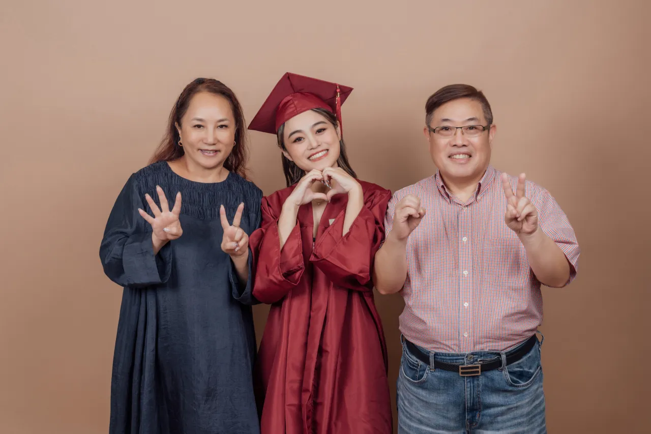 Graduation family photoshoot Singapore - graduate in regalia with family